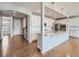 Open layout featuring a kitchen island with granite countertops, stainless steel appliances, and hardwood floors at 10371 Harrisburg St, Parker, CO 80134
