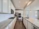Modern kitchen featuring a spacious granite countertop, stainless steel appliances, and custom cabinets at 10371 Harrisburg St, Parker, CO 80134