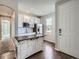 Charming kitchen features white cabinetry, stainless steel appliances, and an island with wood countertop at 10371 Harrisburg St, Parker, CO 80134