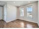 Bright living room featuring hardwood floors and large windows with neighborhood views at 10371 Harrisburg St, Parker, CO 80134