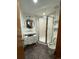 A bathroom with vanity and sink, toilet, and standing shower with glass door at 4992 S Elkhart Ct, Aurora, CO 80015