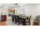 Bright dining room features modern light fixture, wood table, and access to the kitchen at 7476 E Arkansas Ave # 35-01, Denver, CO 80231
