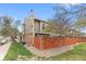 Exterior view of home with brick and siding, green lawn, and fenced yard at 7476 E Arkansas Ave # 35-01, Denver, CO 80231