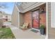 Charming front porch featuring a cozy wooden chair and a welcoming entrance with brick accents at 7476 E Arkansas Ave # 35-01, Denver, CO 80231