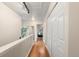 Hallway with hardwood floors, closet space, and access to additional rooms at 7476 E Arkansas Ave # 35-01, Denver, CO 80231