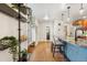 Open-concept hallway and kitchen includes a plant ledge and a stylish breakfast bar at 7476 E Arkansas Ave # 35-01, Denver, CO 80231
