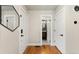 Bright hallway with hardwood floors, white doors, and a glimpse of a modern bathroom at 7476 E Arkansas Ave # 35-01, Denver, CO 80231