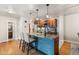 Open kitchen with stainless appliances, granite counters, island seating, and a view to an adjoining laundry area at 7476 E Arkansas Ave # 35-01, Denver, CO 80231