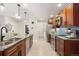 Well-lit kitchen featuring stainless steel appliances, a granite island, and a view to a bathroom at 7476 E Arkansas Ave # 35-01, Denver, CO 80231