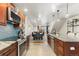 Modern kitchen with stainless steel appliances, granite countertops, and an adjacent dining area at 7476 E Arkansas Ave # 35-01, Denver, CO 80231