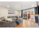 Inviting living room with a gray sofa, stylish decor, hardwood floors, and natural light at 7476 E Arkansas Ave # 35-01, Denver, CO 80231