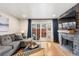 Cozy living room with hardwood floors, fireplace, comfortable seating, and sliding doors to the patio at 7476 E Arkansas Ave # 35-01, Denver, CO 80231