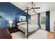 Bedroom boasts a statement wall, canopy bed, hardwood floors, and natural light at 7476 E Arkansas Ave # 35-01, Denver, CO 80231