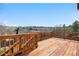 Wooden back deck with wooden railing offering views of surrounding landscape and neighborhood at 10234 W Geddes Cir, Littleton, CO 80127