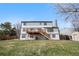 Two-story home featuring back deck, lawn, and storage shed in spacious backyard at 10234 W Geddes Cir, Littleton, CO 80127