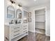 A stylish bathroom features a double vanity, elegant mirrors, and a spacious walk-in closet at 10234 W Geddes Cir, Littleton, CO 80127