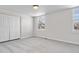 An empty bedroom has plush carpeting, a large window, and a spacious closet at 10234 W Geddes Cir, Littleton, CO 80127