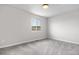 An empty bedroom has plush carpeting and a large window with natural light at 10234 W Geddes Cir, Littleton, CO 80127
