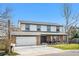Well-maintained two-story home with an attached two-car garage and a neatly landscaped front yard at 10234 W Geddes Cir, Littleton, CO 80127