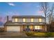 Charming two-story home with brick and siding, featuring a well-manicured lawn and an attached two-car garage at 10234 W Geddes Cir, Littleton, CO 80127
