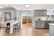 Open concept kitchen with counter seating, hardwood floors, and sliding glass doors to the backyard deck at 10234 W Geddes Cir, Littleton, CO 80127