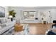 Cozy living room featuring hardwood floors, a window seat, and a decorative rug at 10234 W Geddes Cir, Littleton, CO 80127