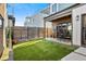 Well-maintained backyard with artificial turf, wood fence, and a cozy patio for outdoor dining at 3636 Lipan St, Denver, CO 80211