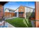 Quaint backyard featuring artificial grass, a patio, privacy fence, and decorative accents at 3636 Lipan St, Denver, CO 80211