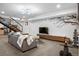 Finished basement with modern lighting, open staircase, and entertainment area with a mounted television at 3636 Lipan St, Denver, CO 80211