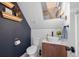 Stylish powder bathroom with a vessel sink, modern vanity, and a unique patterned accent wall at 3636 Lipan St, Denver, CO 80211