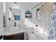 Charming bathroom featuring a white vanity, vessel sink, and hexagon tile accent in the tub and shower area at 3636 Lipan St, Denver, CO 80211