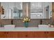 Modern bathroom features dual vessel sinks, modern light fixtures, and beautiful penny tile backsplash at 3636 Lipan St, Denver, CO 80211