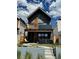 Modern two-story home with a brick facade, balcony, and covered patio featuring an outdoor seating area at 3636 Lipan St, Denver, CO 80211