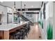 Bright kitchen featuring an island with seating, modern pendant lights, and easy access to the staircase at 3636 Lipan St, Denver, CO 80211