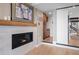 Living room fireplace with hearth, hardwood flooring, and easy access to the kitchen at 3636 Lipan St, Denver, CO 80211