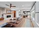 Spacious living room featuring a fireplace, modern ceiling fan, and an open layout to the kitchen at 3636 Lipan St, Denver, CO 80211
