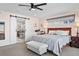 Bedroom boasts a queen bed with barn door entry to en-suite bathroom, neutral walls, and a plush carpet at 3636 Lipan St, Denver, CO 80211