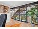 Open concept staircase with black metal beams, light wood steps, a glass partition, and indoor plants at 3636 Lipan St, Denver, CO 80211