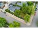 Aerial view of a house with a grassy backyard, sidewalk and street at 1900 S Gilpin St, Denver, CO 80210