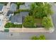 Aerial view of home with lush green backyard, gravel border and adjacent garage at 1900 S Gilpin St, Denver, CO 80210