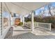 Covered back deck with white railing offers shade and a view of the fenced backyard at 1900 S Gilpin St, Denver, CO 80210