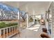 Covered back porch with ample room for seating and potted plants, with views of the backyard at 1900 S Gilpin St, Denver, CO 80210