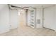 Finished basement area featuring tiled floors, neutral paint, and built-in shelving at 1900 S Gilpin St, Denver, CO 80210