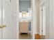 Cozy bathroom featuring a vanity with a mirror and modern sconce lighting at 1900 S Gilpin St, Denver, CO 80210
