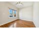 Bright bedroom with hardwood floors, neutral paint, and a large window at 1900 S Gilpin St, Denver, CO 80210