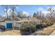 Charming single-story home with a blue garage, inviting front porch, and mature landscaping at 1900 S Gilpin St, Denver, CO 80210