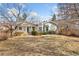 Charming single-story home with a manicured front yard and mature trees, creating a welcoming curb appeal at 1900 S Gilpin St, Denver, CO 80210