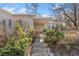 Landscaped walkway leading to the front entrance of this inviting home, surrounded by lush greenery at 1900 S Gilpin St, Denver, CO 80210