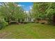 Beautiful house with a large, well-manicured lawn and mature trees providing ample shade at 1900 S Gilpin St, Denver, CO 80210