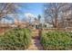 Landscaped front yard with walkway leading to a charming home, framed by greenery and a wooden fence at 1900 S Gilpin St, Denver, CO 80210
